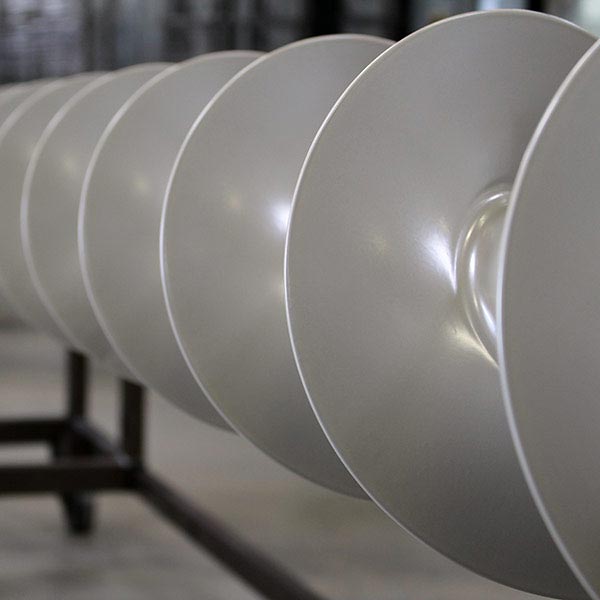 Close-up of a conveyor screw coated with ETFE coating (chemical protection)