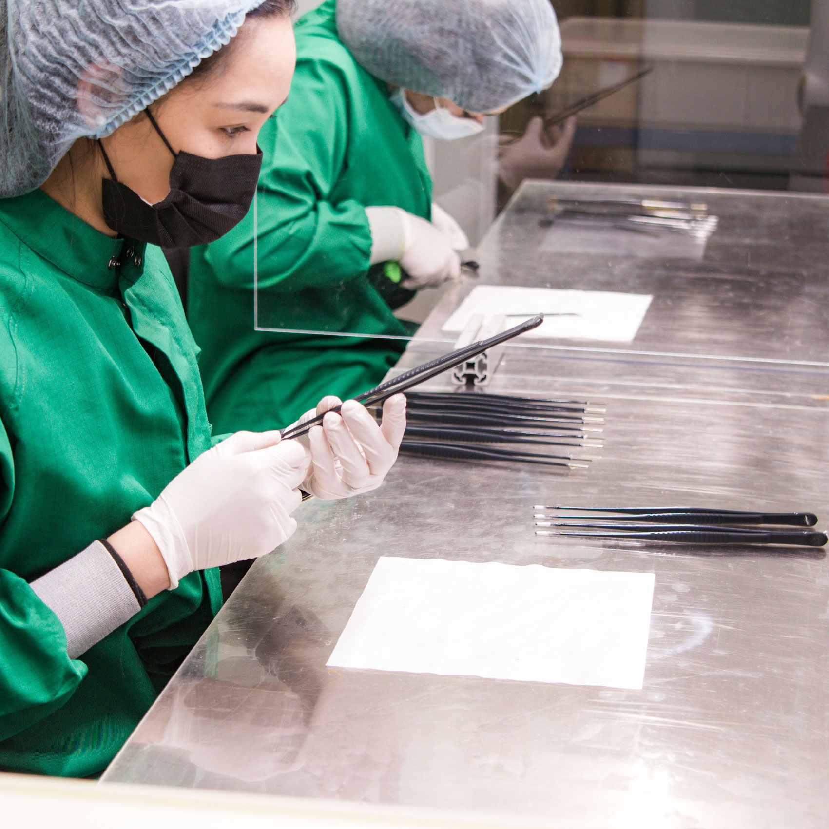 Testing of electrically insulating coating on tweezers in clean room.