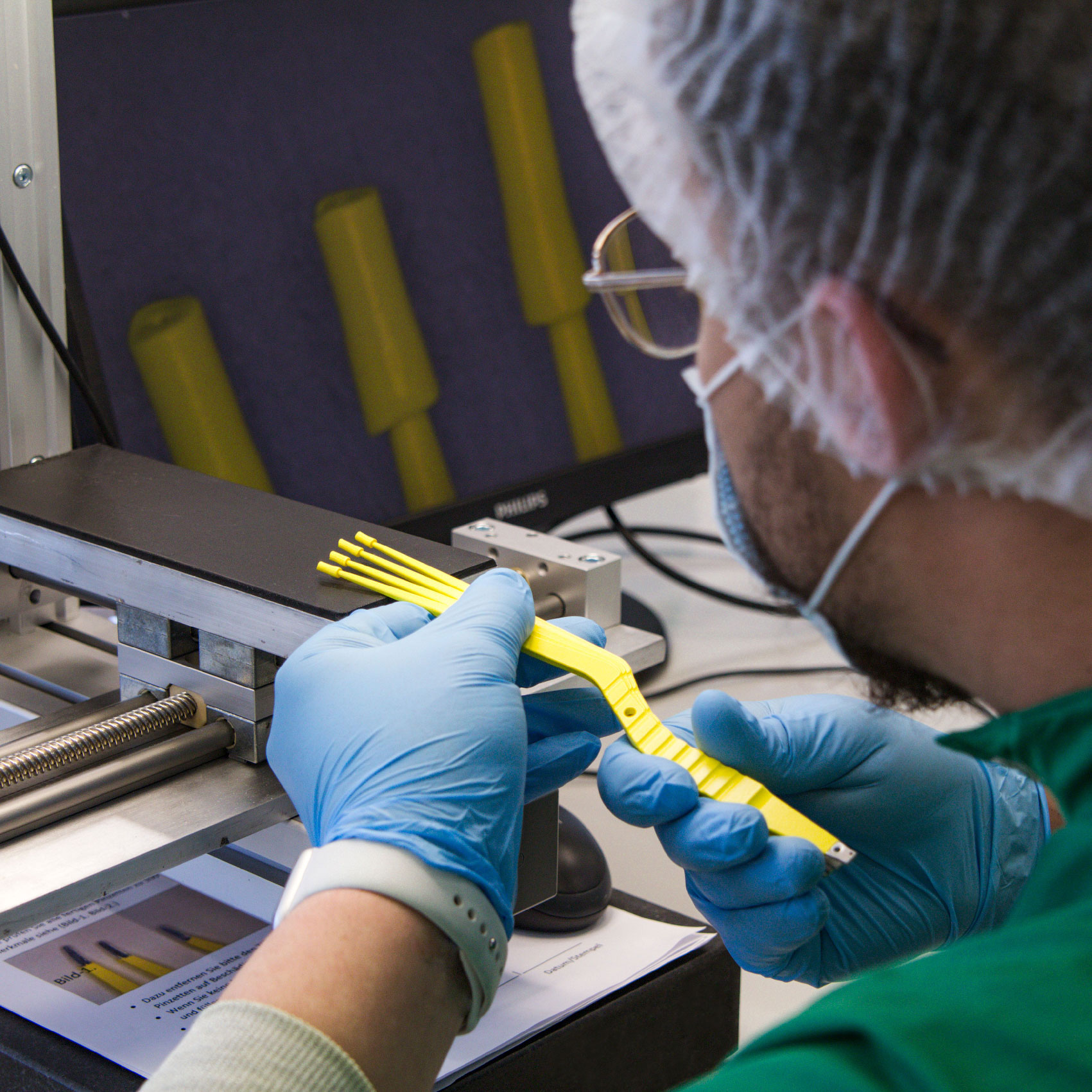 Microscopic testing of tweezers with electrically insulating coating in the clean room.