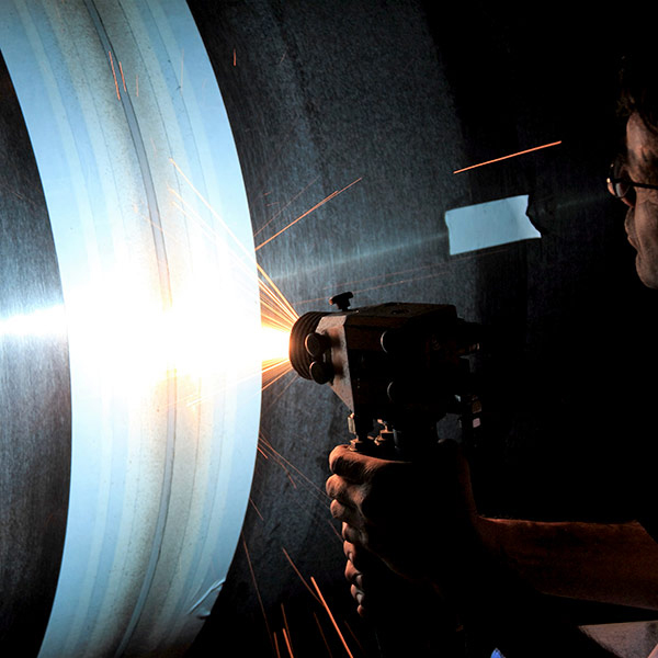 Thermal spraying with electric arc equipment, for wear protection, also called electric arc spraying.